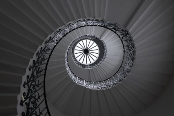 Looking up through the centre black and white spiral stairs