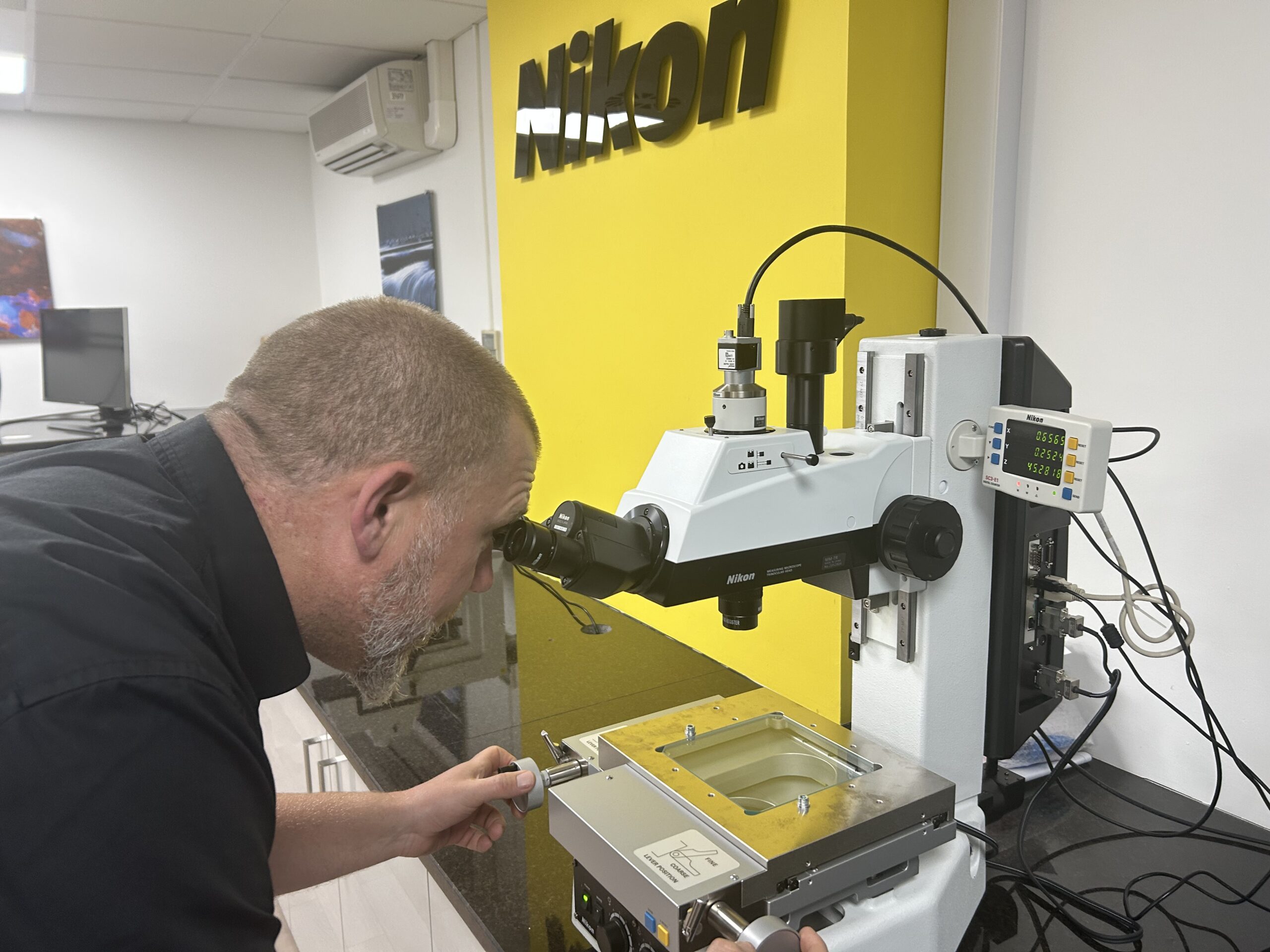 Joe Croxal with a Measuring Microscope, which are known for their reliability and ease of use. 
