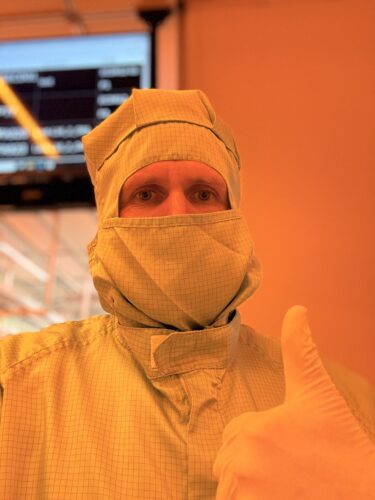 Christian Kraft at a customer site, completely covered in protective clothing before entering a clean room for a NEXIV maintenance service.